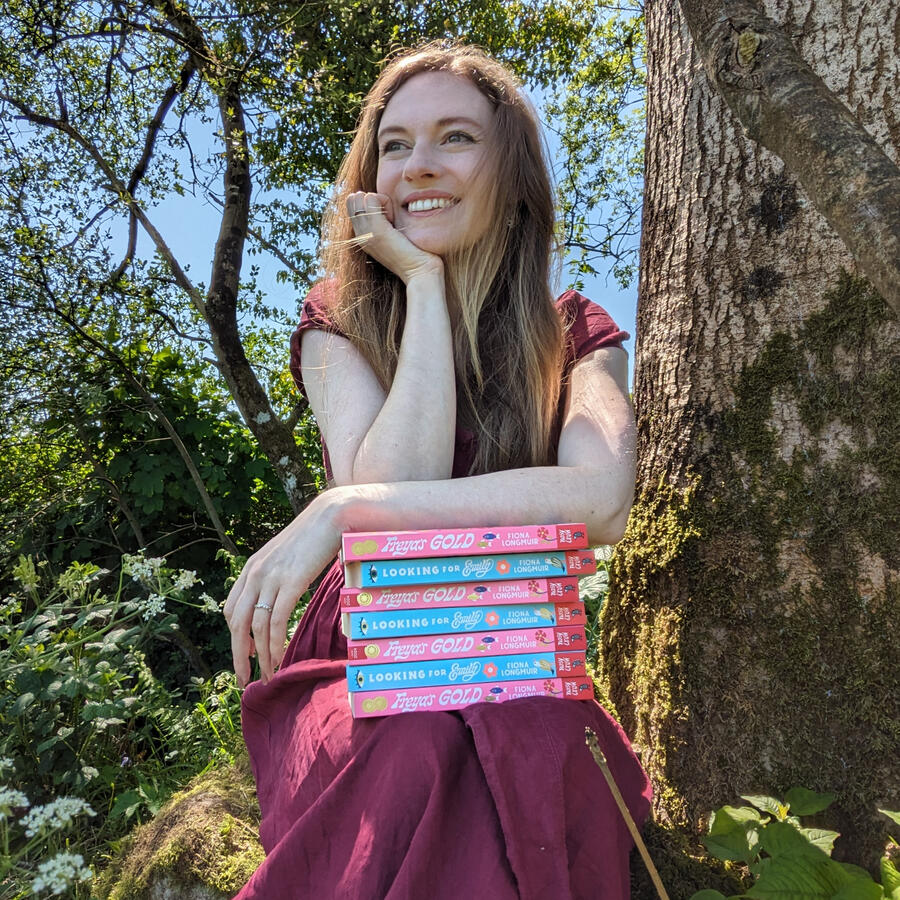 Fiona with stack of Looking for Emily books
